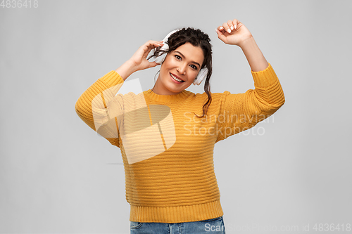 Image of happy woman in headphones listening to music