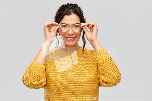Image of happy smiling young woman in glasses