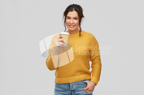 Image of smiling woman with pierced nose holding coffee cup