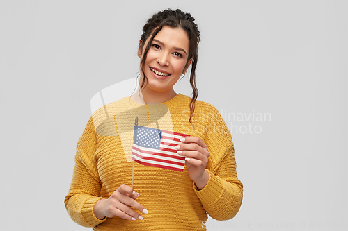Image of happy woman with flag of united states of america