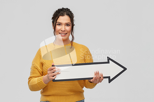 Image of smiling young woman with big white right arrow