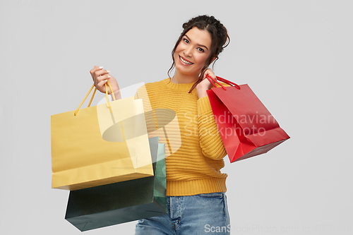 Image of happy smiling young woman with shopping bags