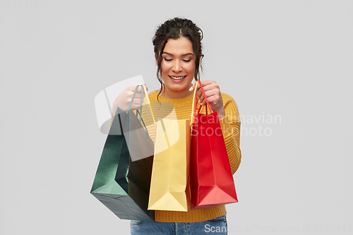 Image of happy smiling young woman with shopping bags