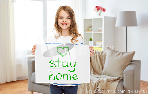 Image of happy girl holding stay home message on paper