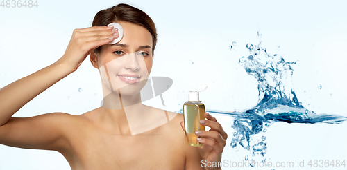 Image of young woman with toner or cleanser and cotton pad