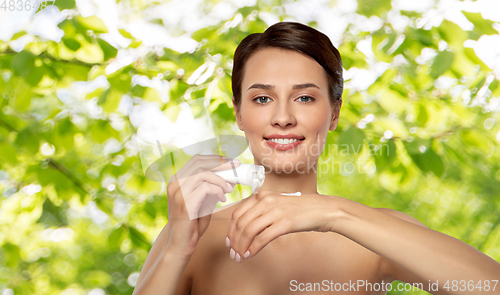 Image of woman applying moisturizing cream to her hand