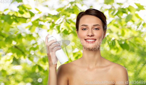 Image of beautiful young woman with hair spray or mist