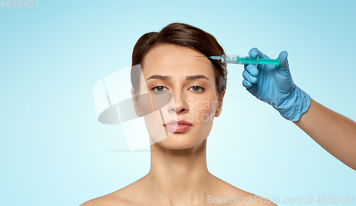 Image of beautiful young woman and hand with syringe