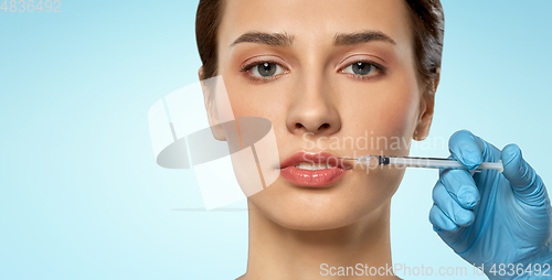 Image of beautiful young woman and hand with syringe