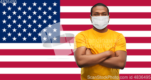 Image of african american man in protective medical mask