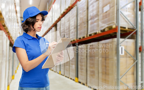 Image of delivery girl with clipboard at warehouse