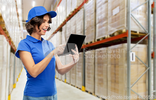 Image of happy delivery girl with tablet pc at warehouse