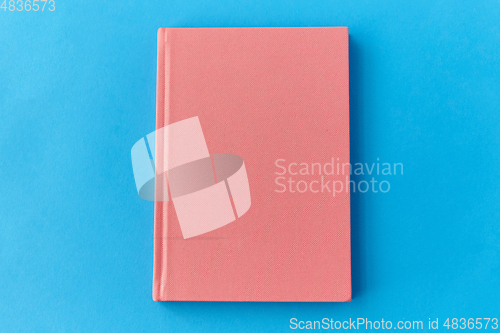 Image of notebook or diary on blue background