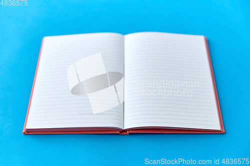 Image of open notebook or diary on blue background