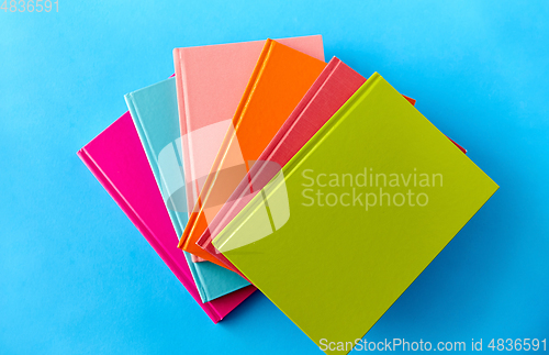 Image of notebooks or books on blue background