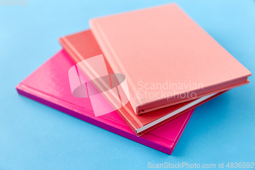 Image of notebooks or books on blue background