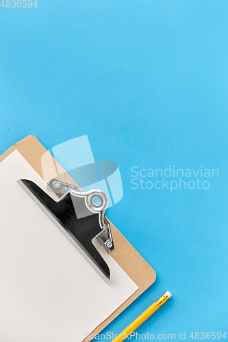 Image of clipboard with white paper sheet and pencil