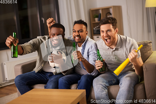 Image of friends or soccer fans with ball and beer at home