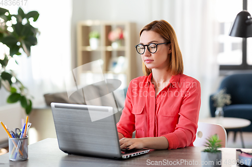 Image of woman with laptop working at home office