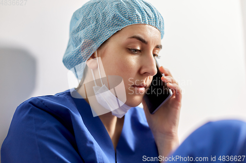 Image of sad doctor or nurse calling on smartphone