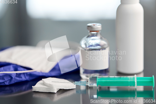 Image of syringe, medicine, wound wipes, gloves and mask