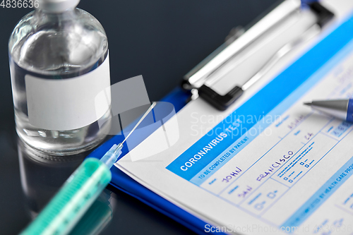 Image of medical report, pen, syringe and medicine