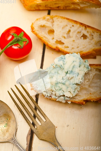 Image of fresh blue cheese spread ove french baguette