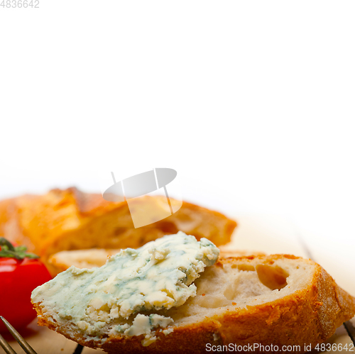 Image of fresh blue cheese spread ove french baguette