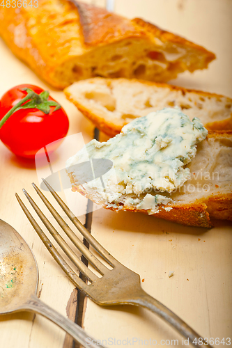 Image of fresh blue cheese spread ove french baguette