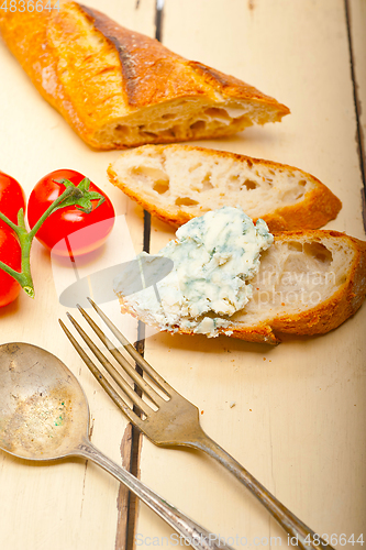 Image of fresh blue cheese spread ove french baguette