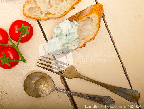 Image of fresh blue cheese spread ove french baguette