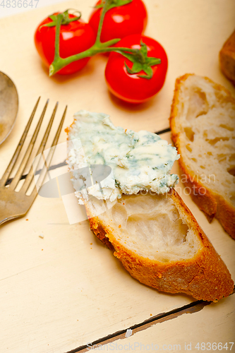 Image of fresh blue cheese spread ove french baguette