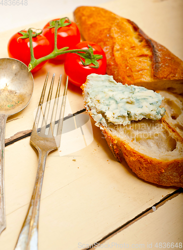 Image of fresh blue cheese spread ove french baguette