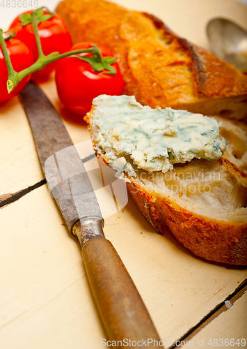 Image of fresh blue cheese spread ove french baguette