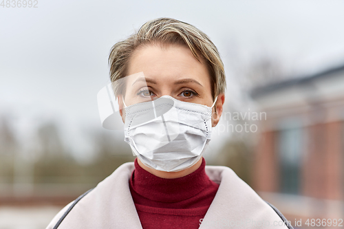 Image of young woman wearing protective medical mask