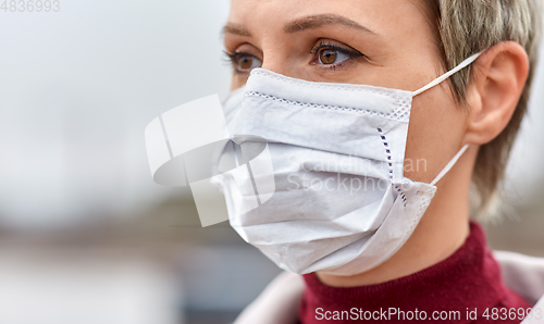 Image of young woman wearing protective medical mask