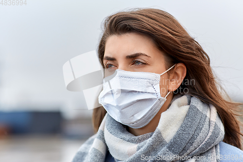 Image of young woman wearing protective medical mask