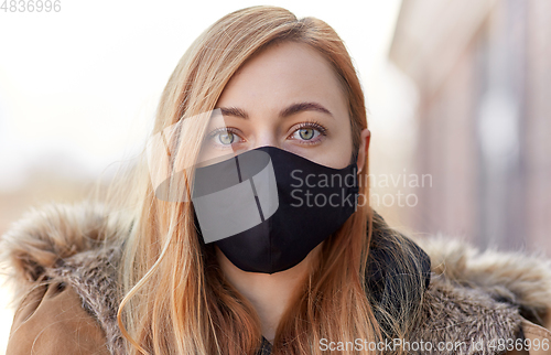 Image of woman wearing protective reusable barrier mask