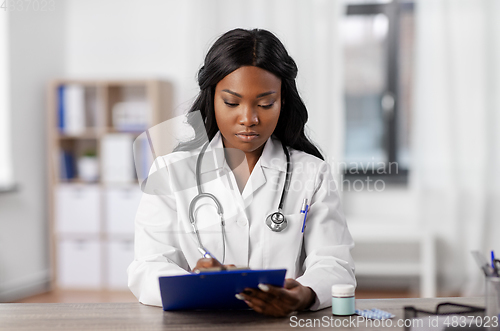 Image of african american doctor with clipboard at hospital