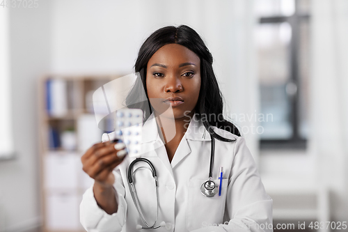 Image of african american doctor with medicine at hospital