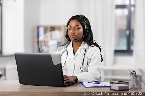 Image of african doctor with headset and laptop at hospital