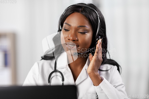 Image of african doctor with headset and laptop at hospital