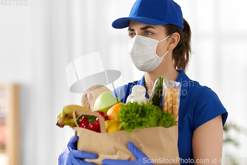 Image of delivery woman in face mask with food in paper bag