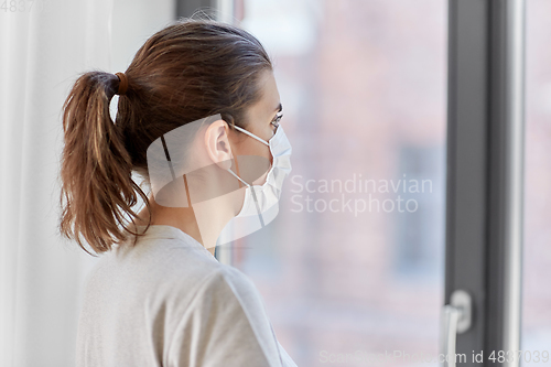 Image of sick young woman wearing protective medical mask