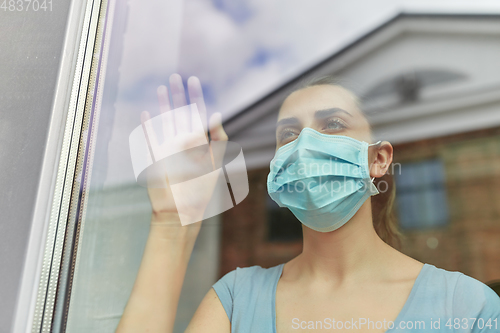 Image of sick young woman wearing protective medical mask