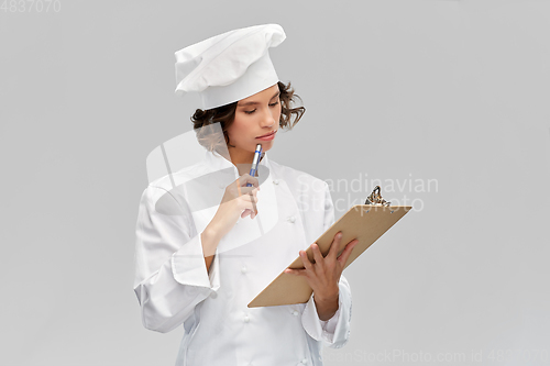 Image of female chef in toque with clipboard
