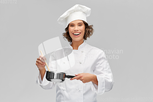 Image of happy smiling female chef with saucepan