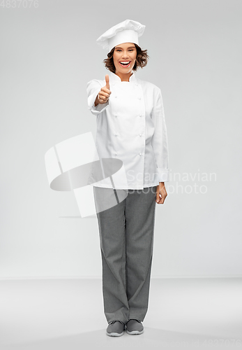 Image of smiling female chef in toque showing thumbs up