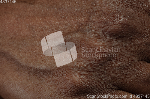 Image of Texture of human skin. Close up of african-american male body