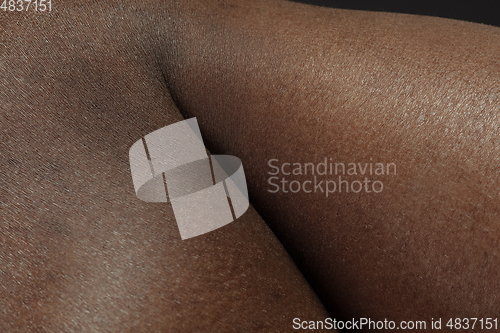 Image of Texture of human skin. Close up of african-american male body